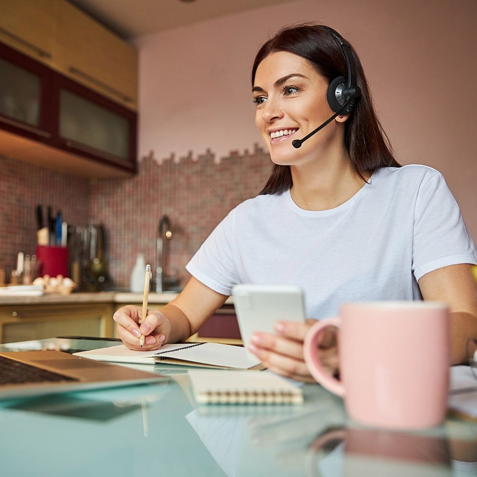 Remote assistant working from home using laptop and headset